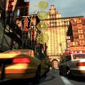 A taxi and police car travel through China Town.