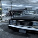 Niko drives a black vehicle while the sky above is dark and grey.